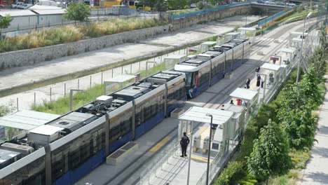 a tram waiting at a station in a city