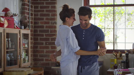 Happy-Hispanic-couple-dancing-in-kitchen-in-the-morning,-shot-on-R3D