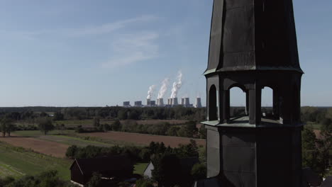 gothic german church steeple tower in rural village, aerial dolly zoom vertigo