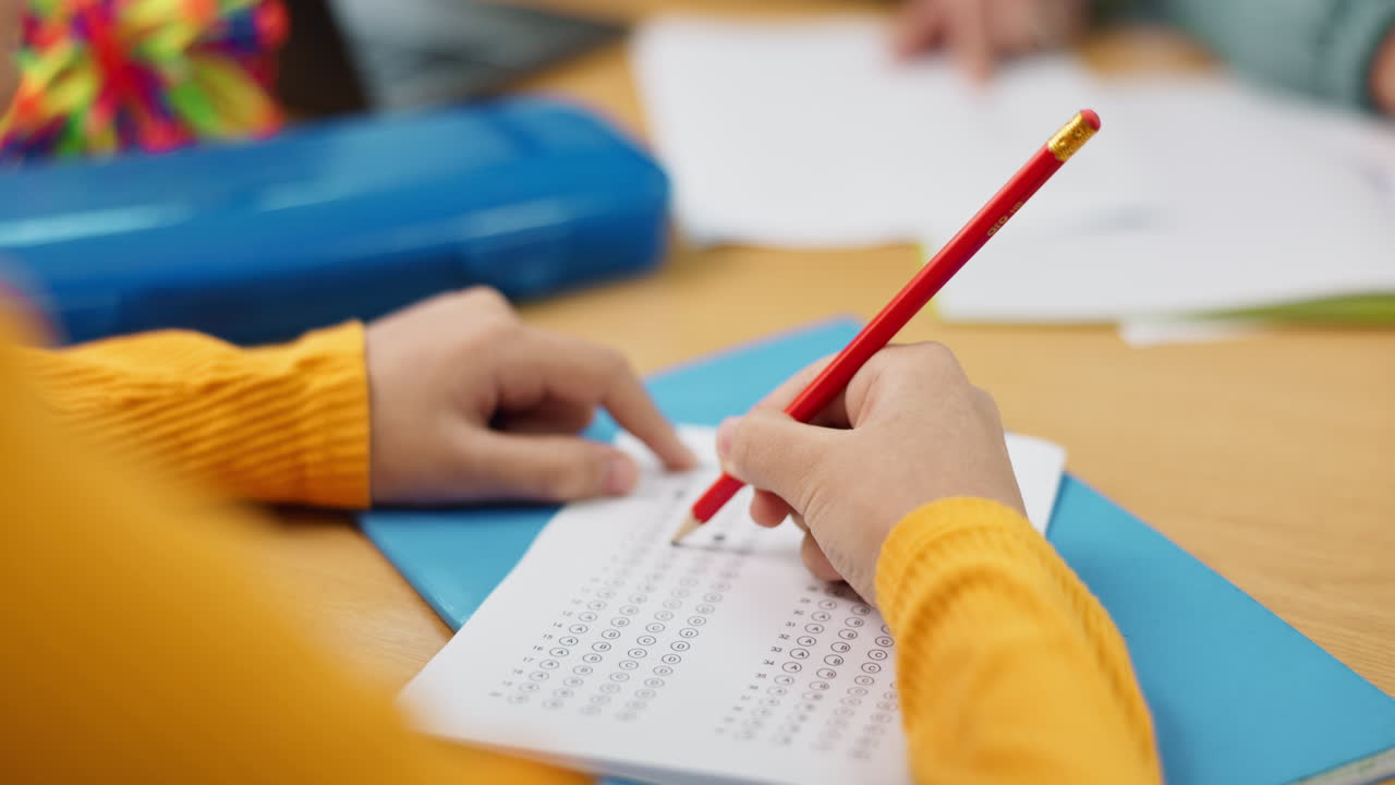 Student taking an exam with a pencil