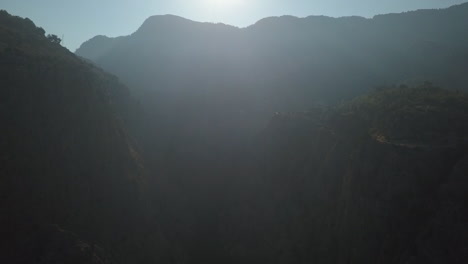 ethereal nature aerial in foggy misty haze in deep steep valley