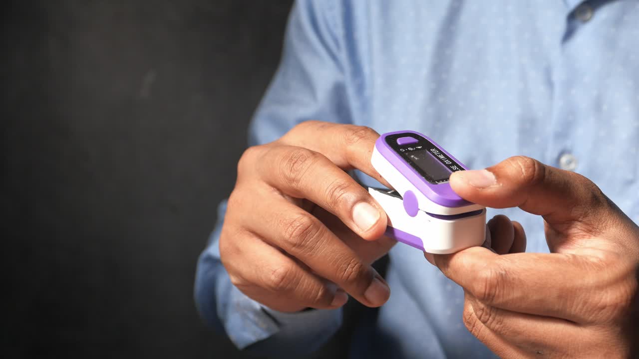 Person using a pulse oximeter