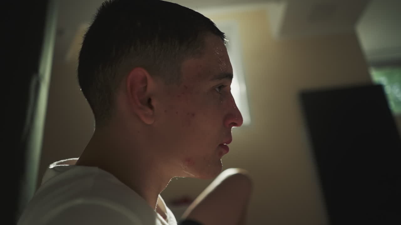 낙담한 남자는 스포츠 클럽의 지하실에서 은 권투 운동을 한 후 휴식을 취합니다. 활기차고 까다로운 스포츠. 강렬한 노력으로 이 흘러내립니다.