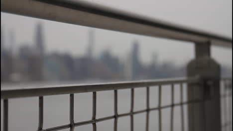 city view through a metal fence