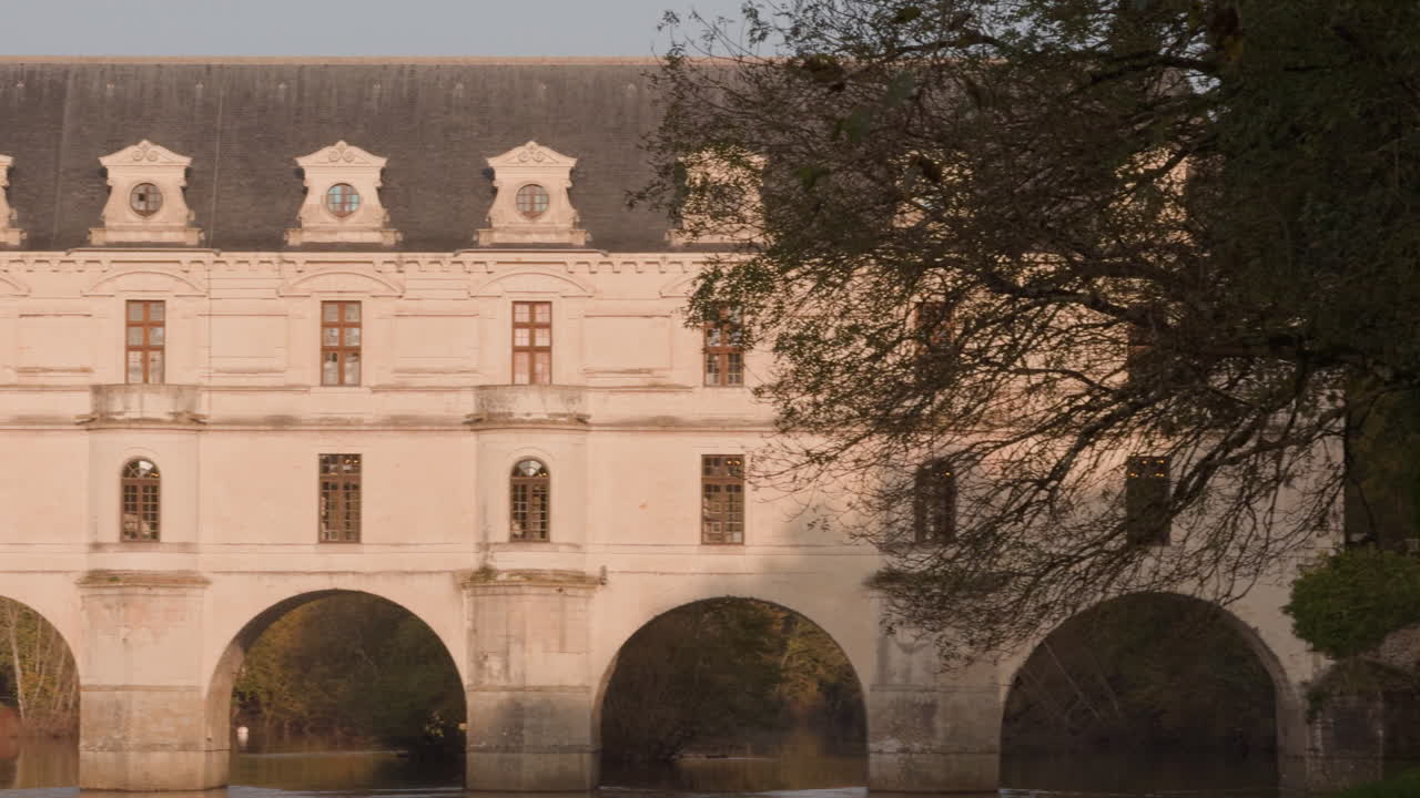 Castle of Chenonceau over the Cher River in the Loire Valley during a warm sunset