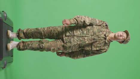 full body of asian man soldier walking and looking around in the green screen background studio