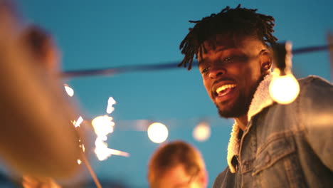 black man, dancing and sparkler in party