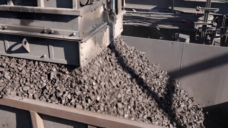 a rapid loading system loads manganese ore into a rail wagon on a mine