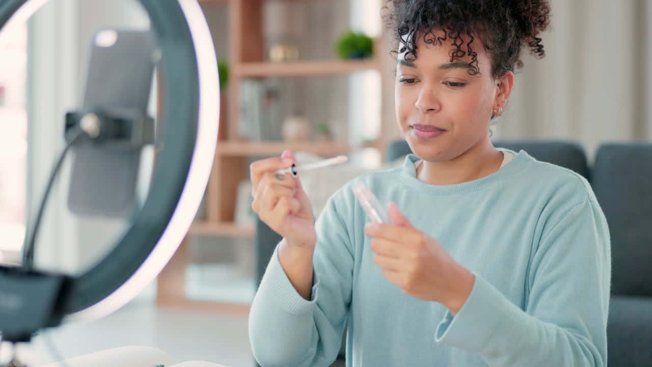 Female vlogger streaming while doing a makeup