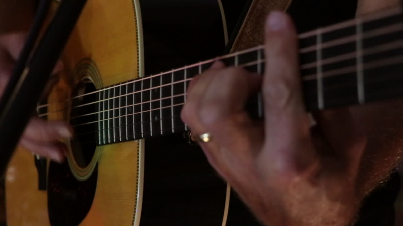 Chitarra acustica strimpellata in primo piano