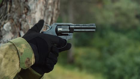 Man-shoots-a-revolver-close-up