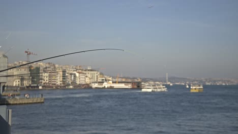 Fishermen-fishing-on-the-Bosphorus,-Galata-Bridge,-with-a-sea-view