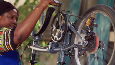 mujer negra examinando piezas de bicicleta