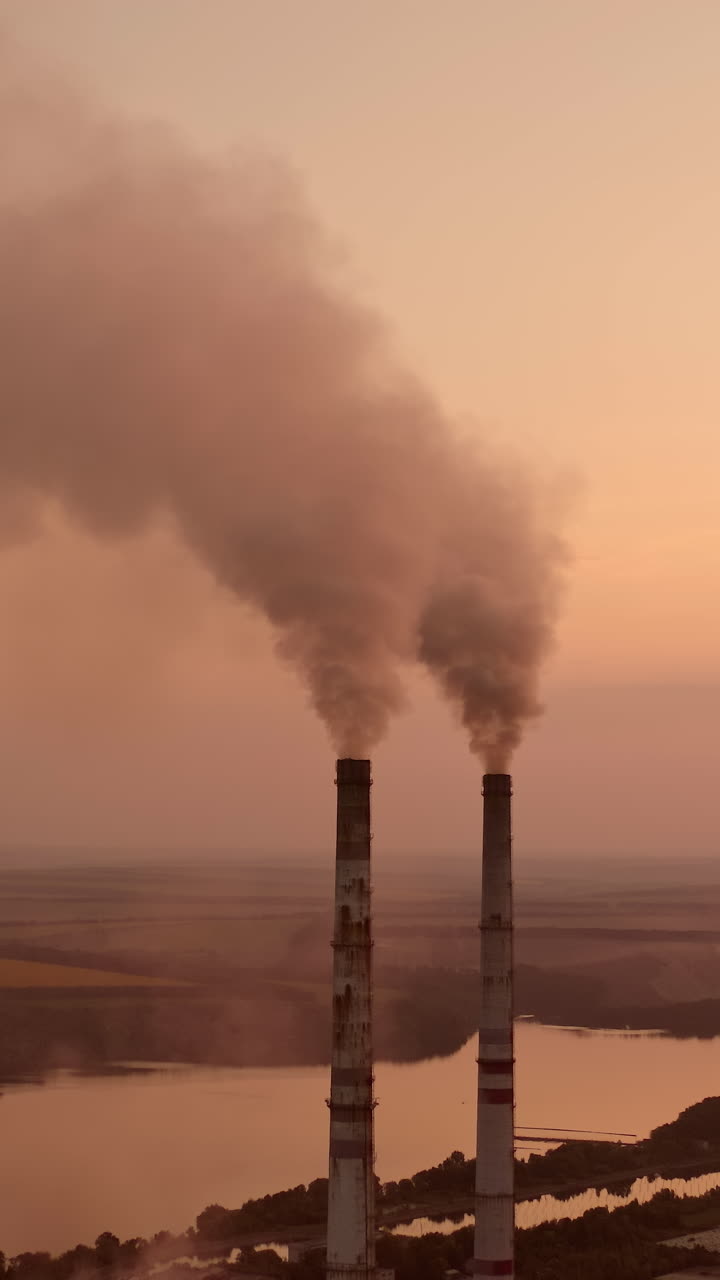 Factory construction engineering. Industry factory gas tubes on sunset. Vertical video