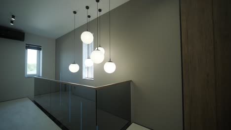 modern hallway with pendant lighting and wood paneling