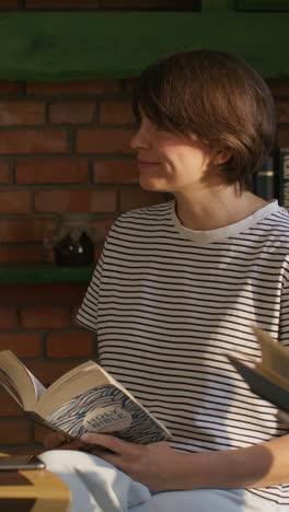 woman reading a book at home