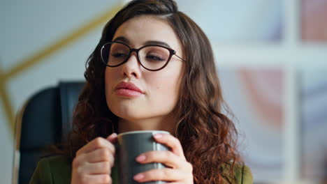 portrait businesswoman drinking coffee in office work break. ceo thinking career