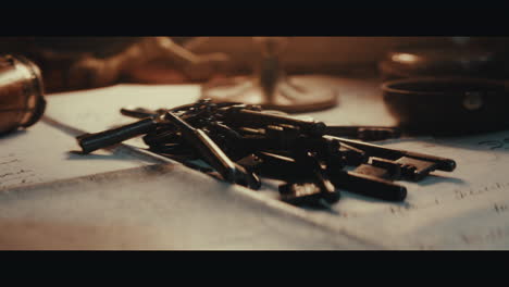 old keys on the table filled with documents and maps inside the sailing ship cabin