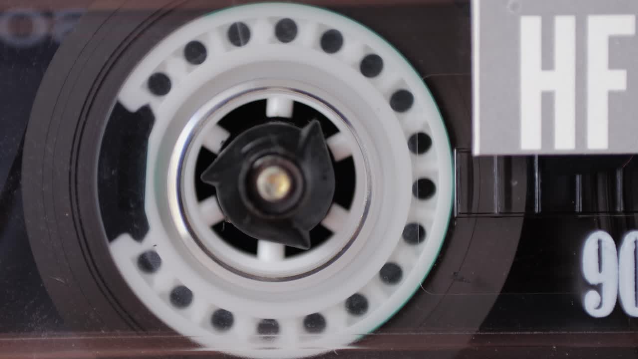 Retro radio tape recorder, audio cassette close-up. Listening to music, old radio boom box player, macro of vintage music listening.