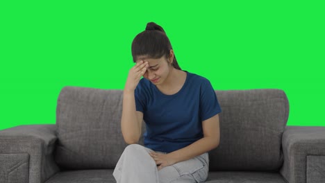 Sick-Indian-teenage-girl-having-a-headache-Green-screen