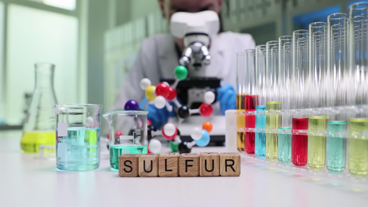 Chemist Conducts Experiment with Sulfur and Lab Equipment in a Laboratory
