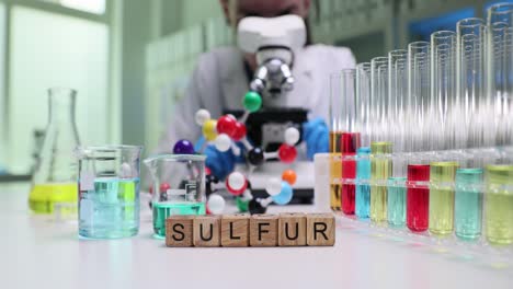 chemist conducts experiment with sulfur and lab equipment in a laboratory