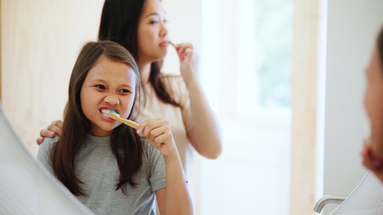 Mother, girl and brushing teeth in morning