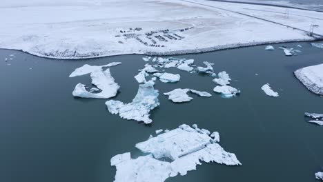 icebergs at the glacier lagoon jökulsárlón in iceland, europe - aerial drone shot