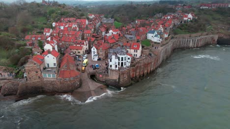 Scenic-Robin's-hood-bay-landmark-village-rooftops-aerial-view-across-coastline