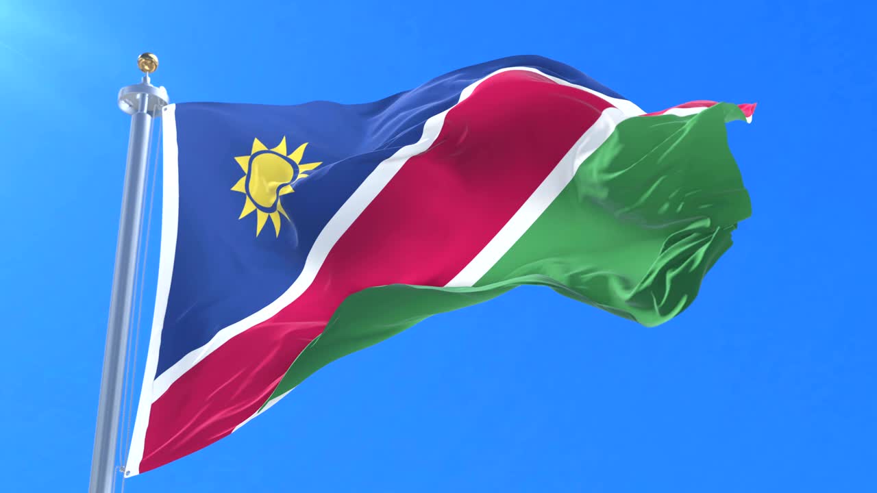 bandera de namibia agitando en el viento en lento en el cielo azul, bucle