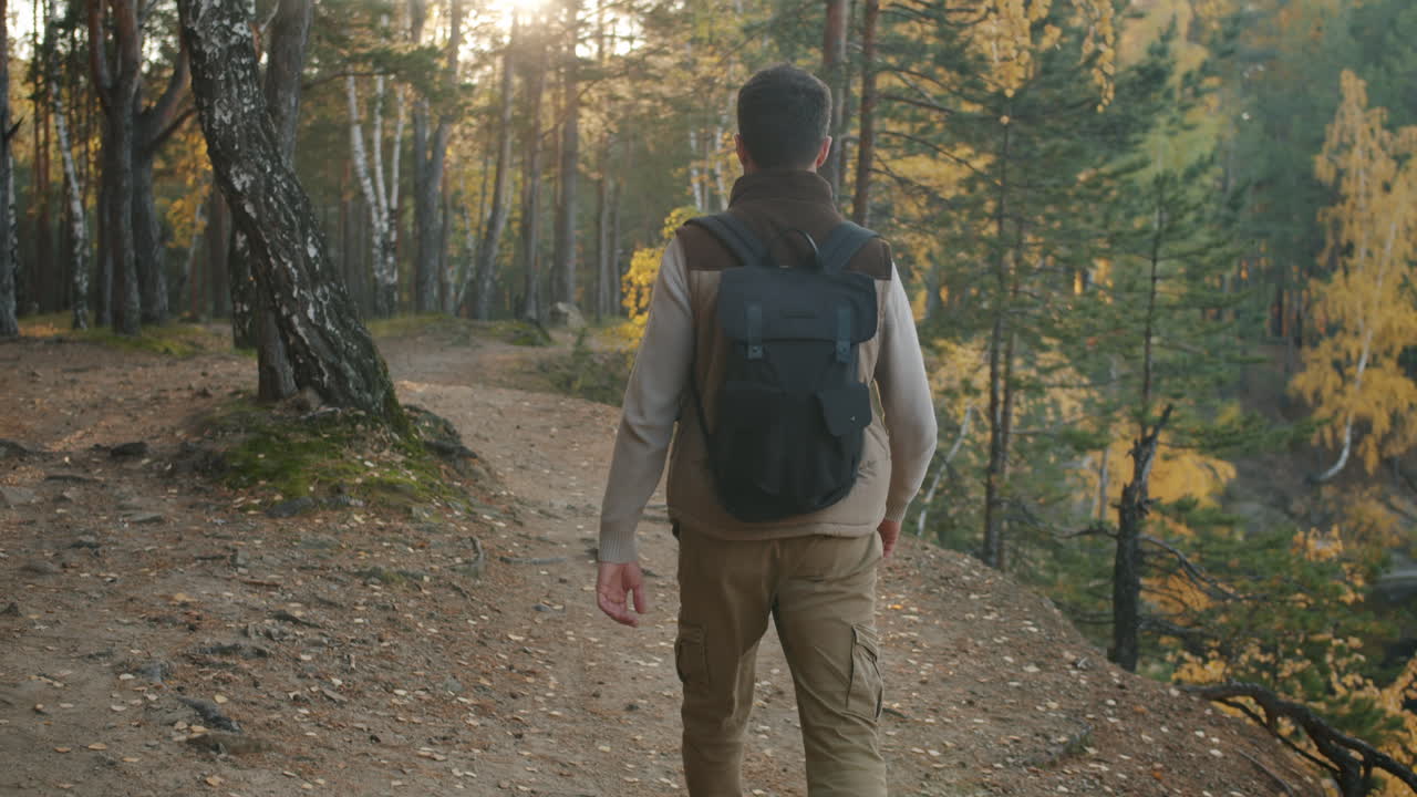 hombre caminando en el bosque de otoño