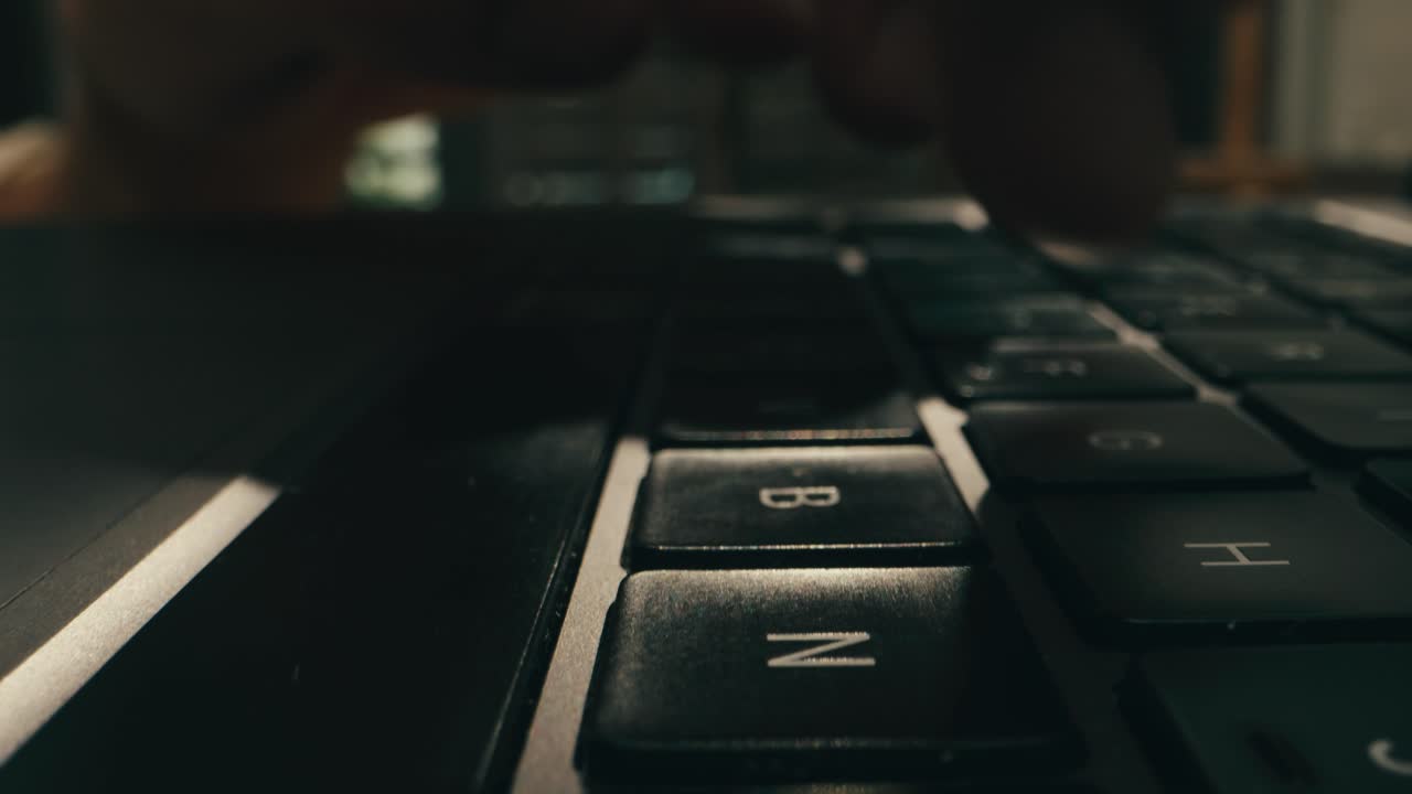Closeup of hands typing on a laptop, showcasing productivity and advanced technology in a modern workspace
