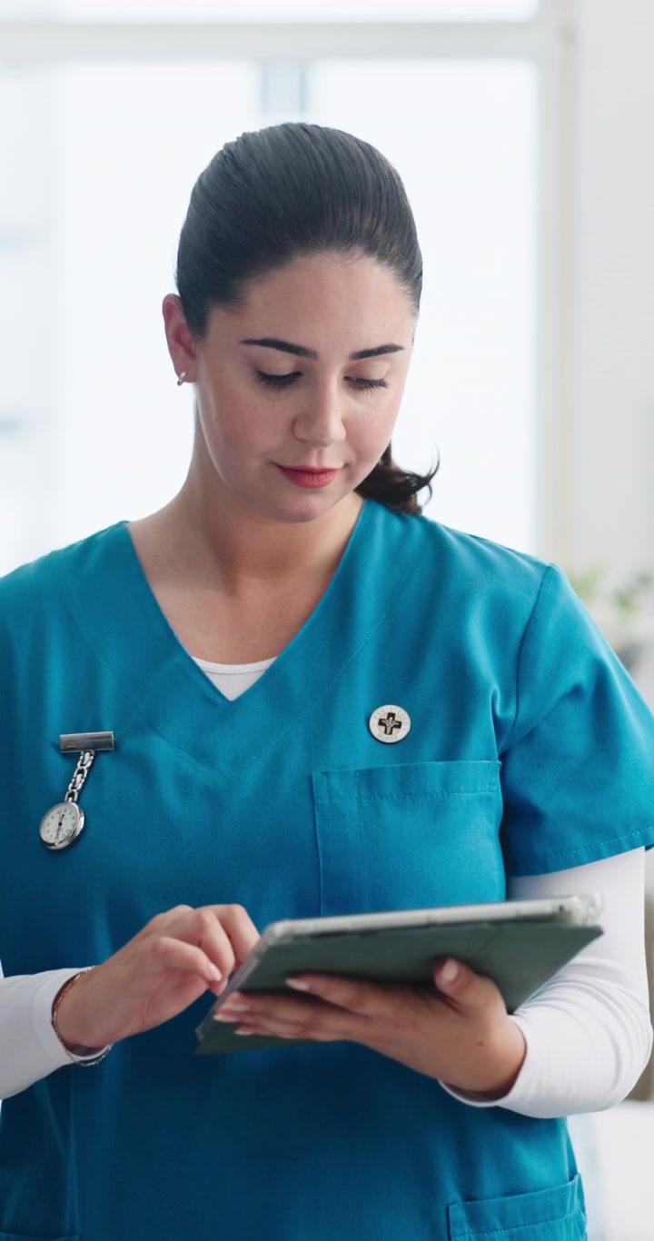 Female Nurse Using Digital Tablet in Hospital