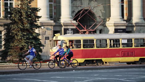 city street scene with tram and cyclists