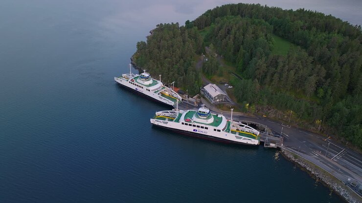 Sustainable car ferry moored in norwegian fjord, Aerial orbit