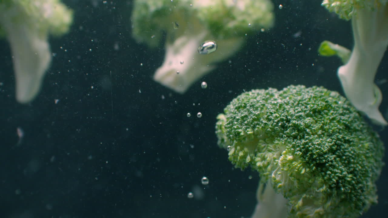 Broccoli Under water with air bubbles and in slow motion. Fresh and juicy healthy vegetarian product.