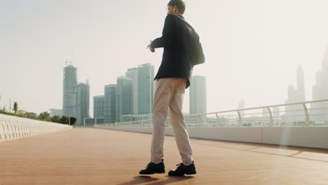 businessman walking in a cityscape, listening to music