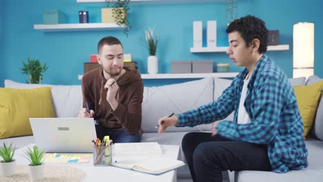 the younger brother gets help from his older brother while studying at home.