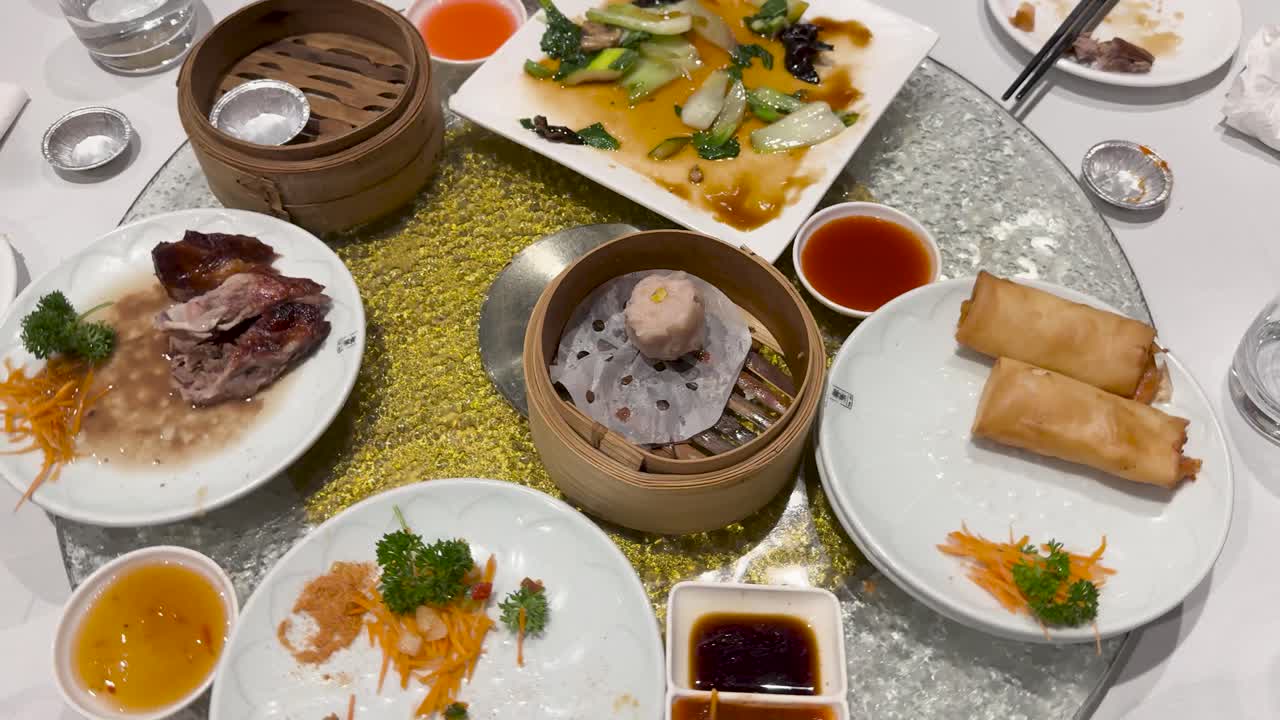 A variety of dim sum dishes on a rotating table, showcasing vibrant colors and diverse textures