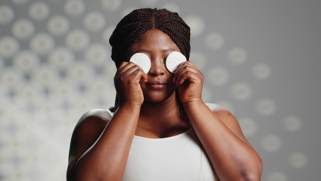 Woman using cotton pads for skincare