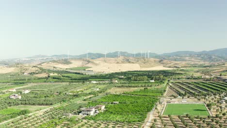 panoramic view of the calabria coastline, olives fields,agricultural fields and wind turbines in the background, calabria, italy