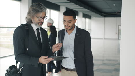 businessmen discussing contract in an empty office building