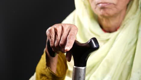 elderly woman with walking stick