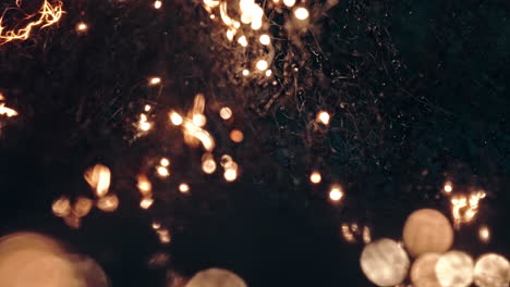 flames rising, glowing fire burning through dark branches and glowing embers
