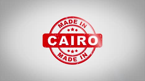 hecho en el cairo firmado estampado texto animación de sello de madera. tinta roja en papel blanco limpio fondo de superficie con fondo matte verde incluido.