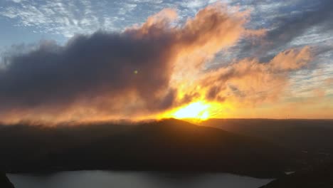 An-aerial-time-lapse-over-Storm-King-Mountain-in-Upstate-New-York-during-a-beautiful-sunrise-with-low-lying-clouds