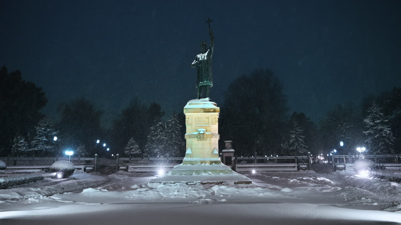 Stephen the Great monument during a snowfall. Blue hour. Winter evening in Chisinau, Moldova