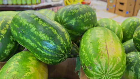 crisp 4k close-up of ripe green watermelons stacked in a market. perfect for food, farming, retail, or summer themes. ideal for advertising, nutrition, and grocery concepts.