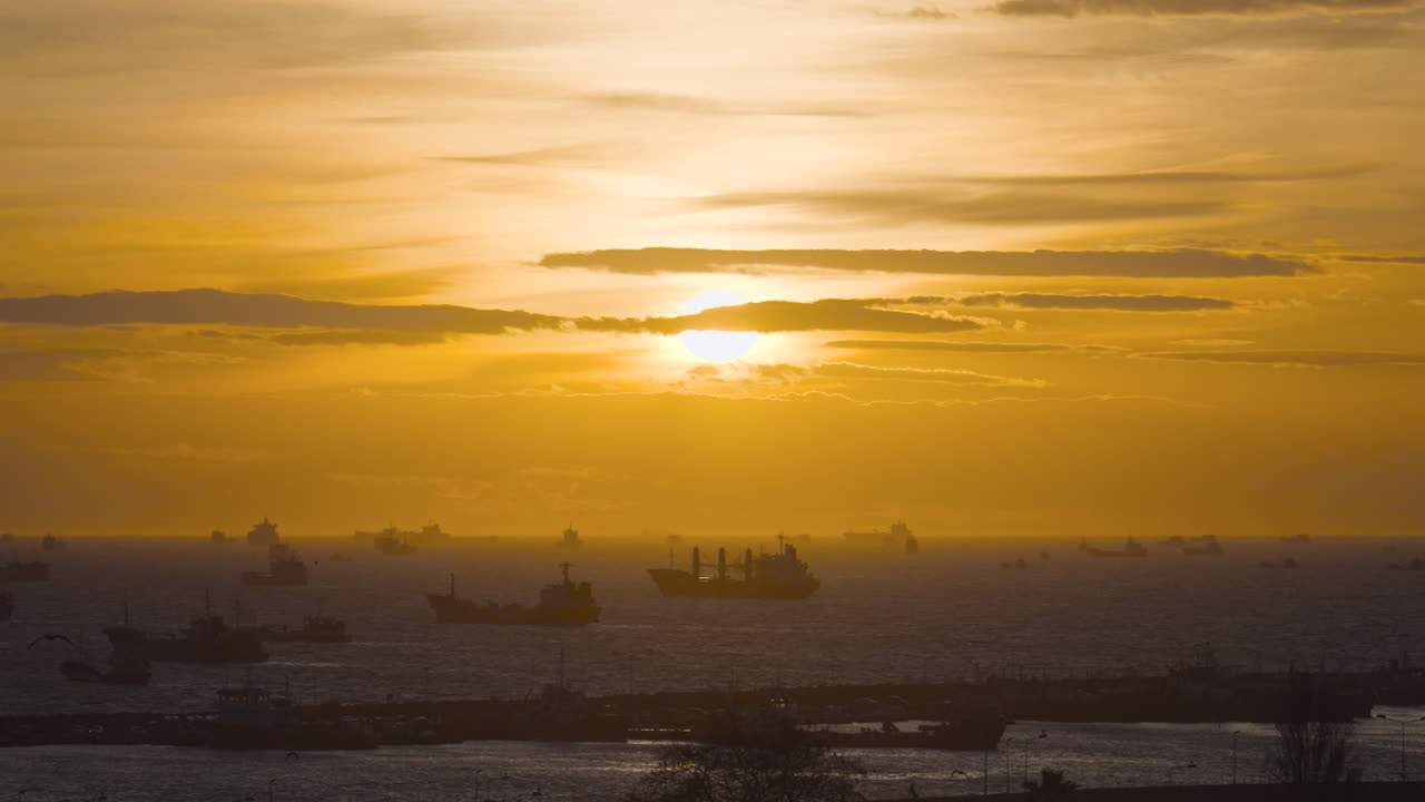 Sunset over a busy port with ships