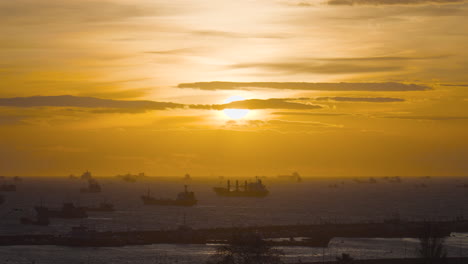 sunset over a busy port with ships